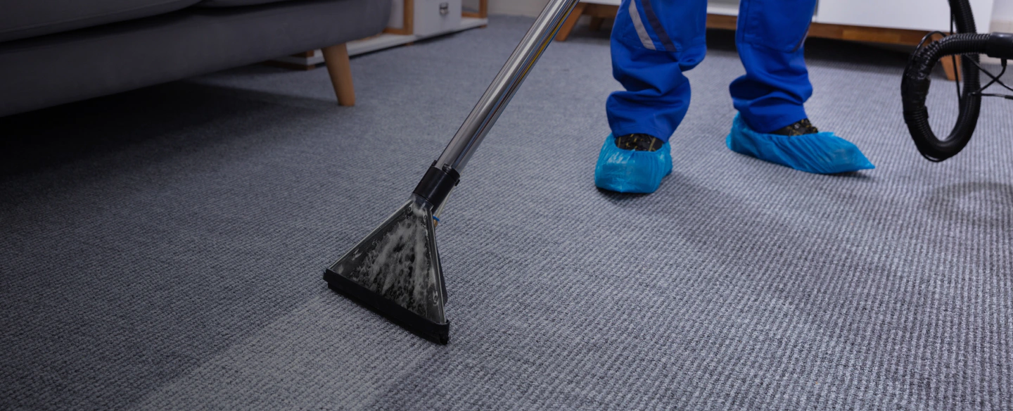 male janitor cleaning carpet